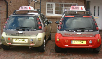 One of our manual learners cars and our automatic learner vehicle, parked in Livingston